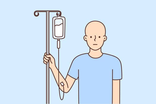 Bald man with dropper get chemo treatment
