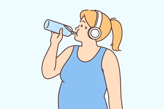 Overweight woman in headphones drink water