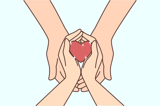 Couple hold heart in hands