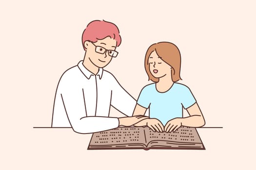 Male tutor teach child reading braille