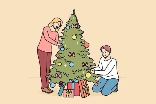 Happy couple decorate Christmas tree
