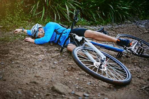 Accidents do happen...a male cyclist whos taken a fall on his mountain bike.