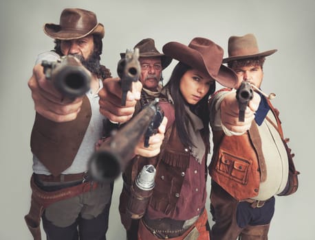 Hand it over...all of it.A band of outlaws standing isolated on gray while pointing their pistols at you.