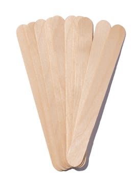 Wooden sticks for applying wax and cosmetic procedures on a white isolated background