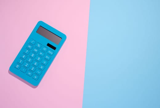 Blue plastic calculator on a blue background, top view