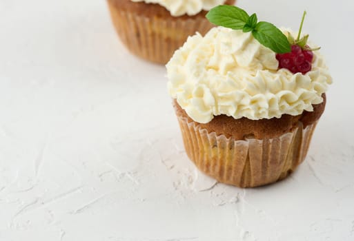 Baked cupcakes with white butter cream on the table, delicious dessert