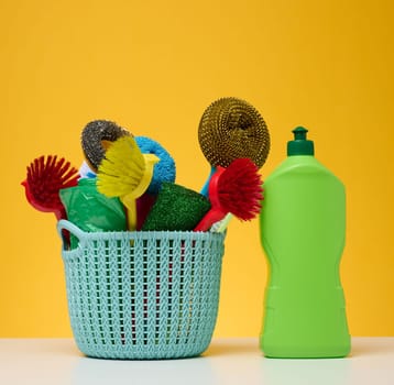 Plastic basket with brushes, disinfectant in a bottle