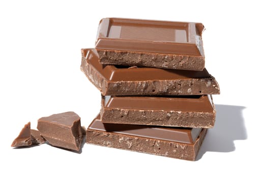 Stack of broken milk chocolate on a white isolated background, square pieces
