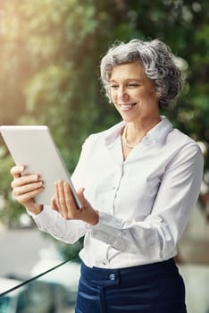 Gaining a competitive with technology. a mature businesswoman working on a digital tablet.