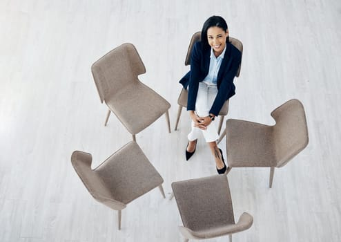 Better a minute too soon than a minute too late. High angle shot of a young businesswoman sitting on a chair in a huddle in an office.
