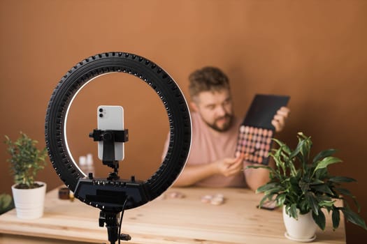 Portrait bearded man making vlog review cosmetics product and channel recording video make up tutorial making at home - Online influencer guy and social media market live steaming concept