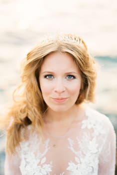 Bride in a white lace dress with a tiara on her hair
