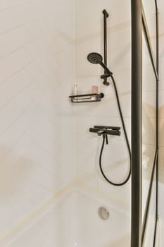 a shower with a shower head in a white bathroom