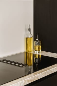 a kitchen sink with a bottle of oil on it