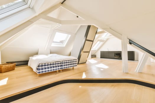 a loft bedroom with a bed and a tv in