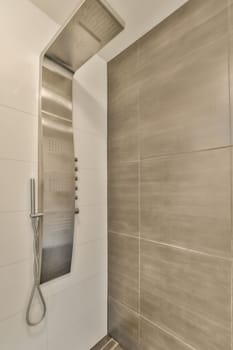 a large white shower with a stainless steel shower head