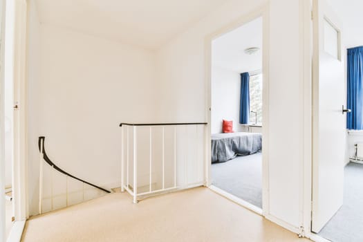 a white bedroom with a white gate in the entrance