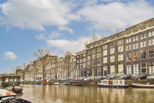 a canal with boats and buildings in amsterdam