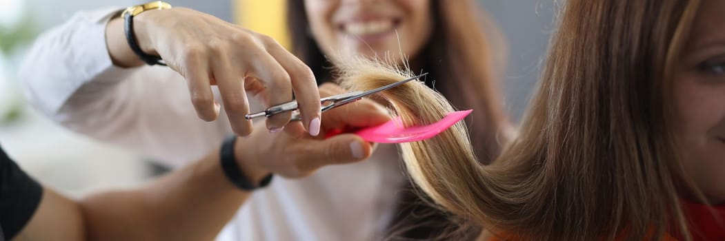 Student in hairdressing is learning how to cut hair