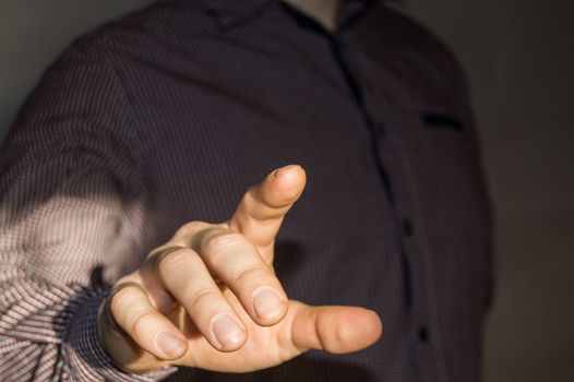 Businessman pointing finger at blank virtual screen by pressing a virtual button