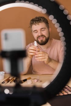 Bearded man professional beauty make up artist vlogger or blogger recording makeup tutorial to share on website or social media.