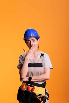 Tired exhausted woman constructor yawning