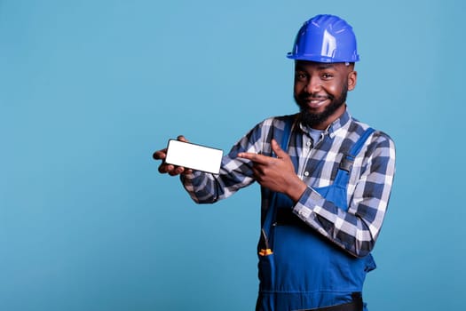 Builder pointing finger at cell phone screen