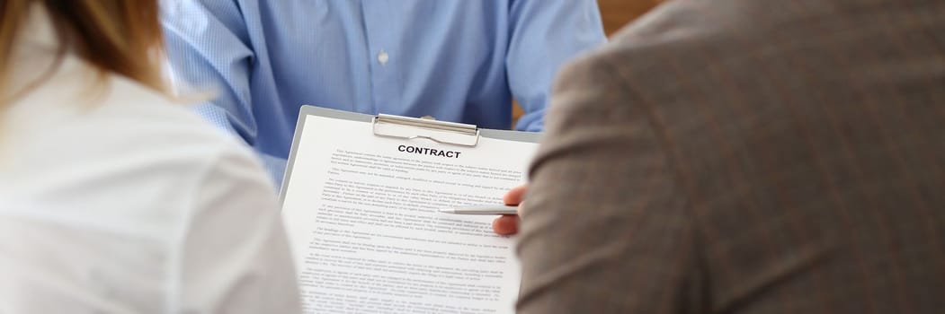 Married couple signs contract to buy house from male realtor or broker