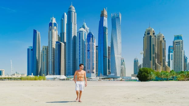 Young man in a swim short on the beach in Dubai, Jumeirah beach Dubai United Arab Emirates