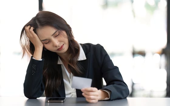 Stress, credit card or business woman with laptop confused with finance, burnout or budget depression in office. Document, bill or employee with headache for loan payment decline