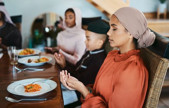 Dont forget to bless your meal. a muslim family praying before eating.
