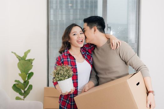 Young asian couple moving to a new apartment together relocation