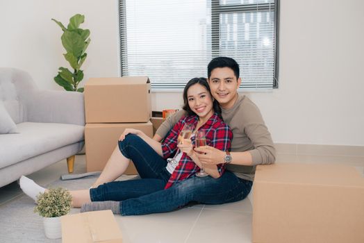 Just married couple of young man and woman feeling unbelievable chilling in their new house