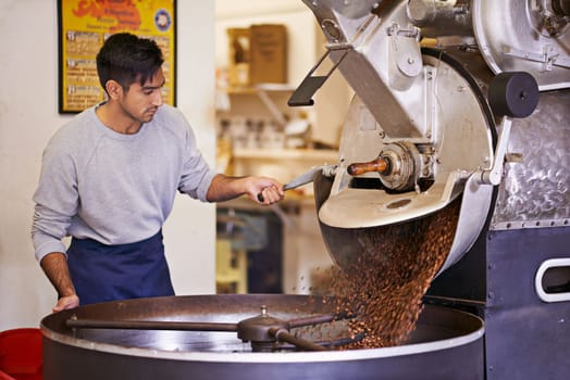 Ready for the brew of your life. a machine grinding and roasting coffee beans.