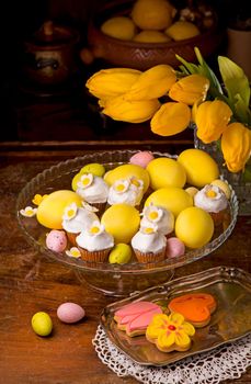 Easter eggs, flowers and muffins. Little cupcake with sugar decorations for easter