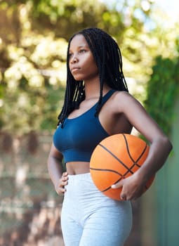 She was born for the court. an attractive young female athlete standing on the basketball court.