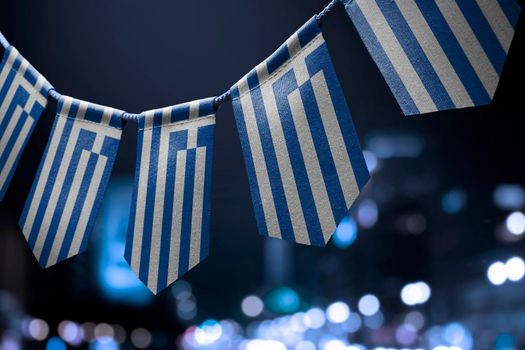 A garland of Greece national flags on an abstract blurred background