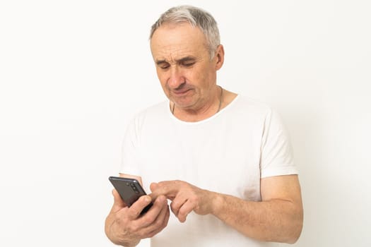 Happy retired man using a smartphone.