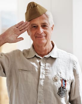 Proud veteran. A senior war veteran looking at the camera wearing his uniform.