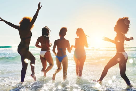 The summer fever is real. a group of happy young women having fun together at the beach.