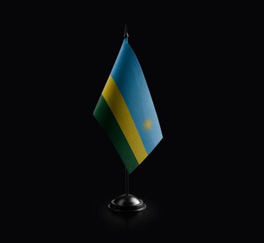 Small national flag of the Rwanda on a black background
