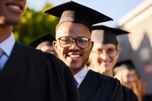 Its my biggest accomplishment yet. Portrait of a university student standing amongst his classmates on graduation day.