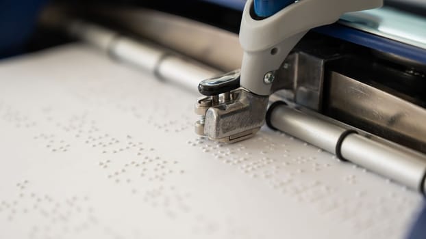 Close-up of a braille code printing machine.