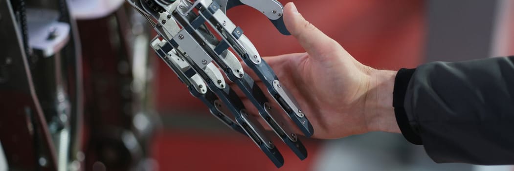 Robot extends its hand to man for handshake