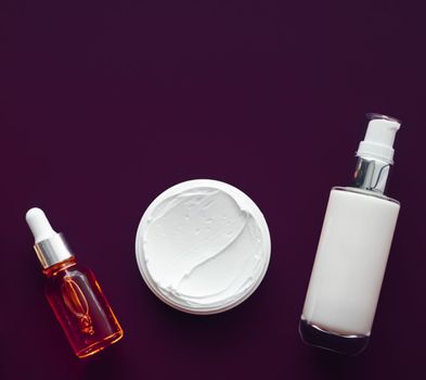 Beauty cosmetics and skincare product on purple background, flatlay