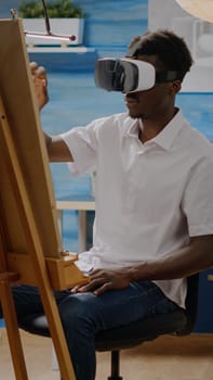 Artist of african american ethnicity using vr glasses for art