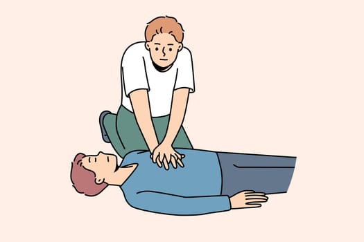 Young man make heart massage to person on ground