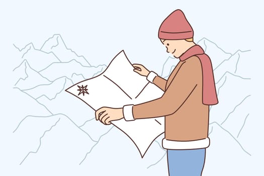 Male traveler with map in mountains