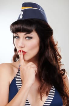 Every sailors dream girl. Sultry sailor girl with her finger to her lips.