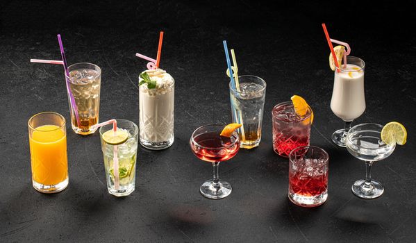 Variety of different cocktails on grey background